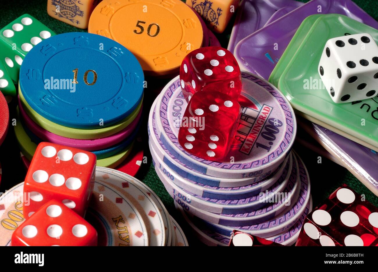 A collection of gambling chips, counters, dice and poker dice. Risk and reward. Stock Photo