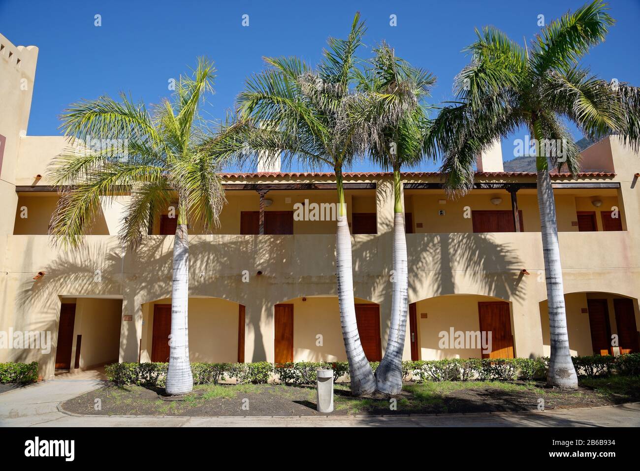 Hotel accommodation with palm trees in hot climate of Southern Europe. Stock Photo