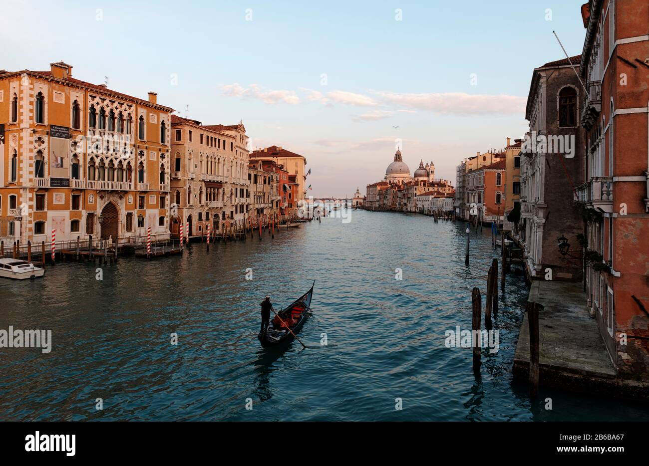 VENICE, ITALY - February 19, 2020 :Picturesque view of Gondolas on Canal Grande with Basilica di Santa Maria della Salute in the background Stock Photo