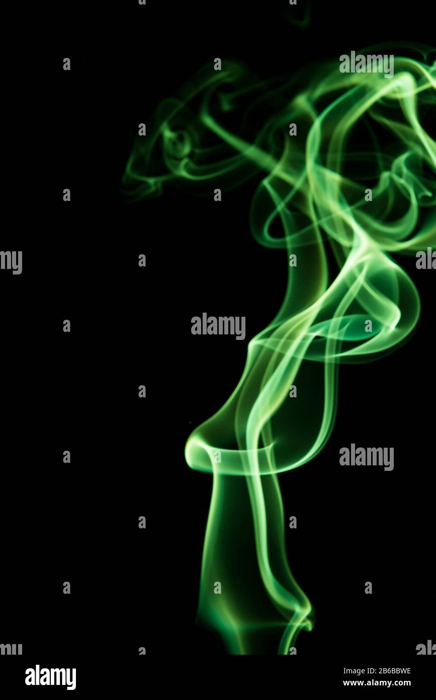 Abstract shape of green smoke on black background Stock Photo - Alamy