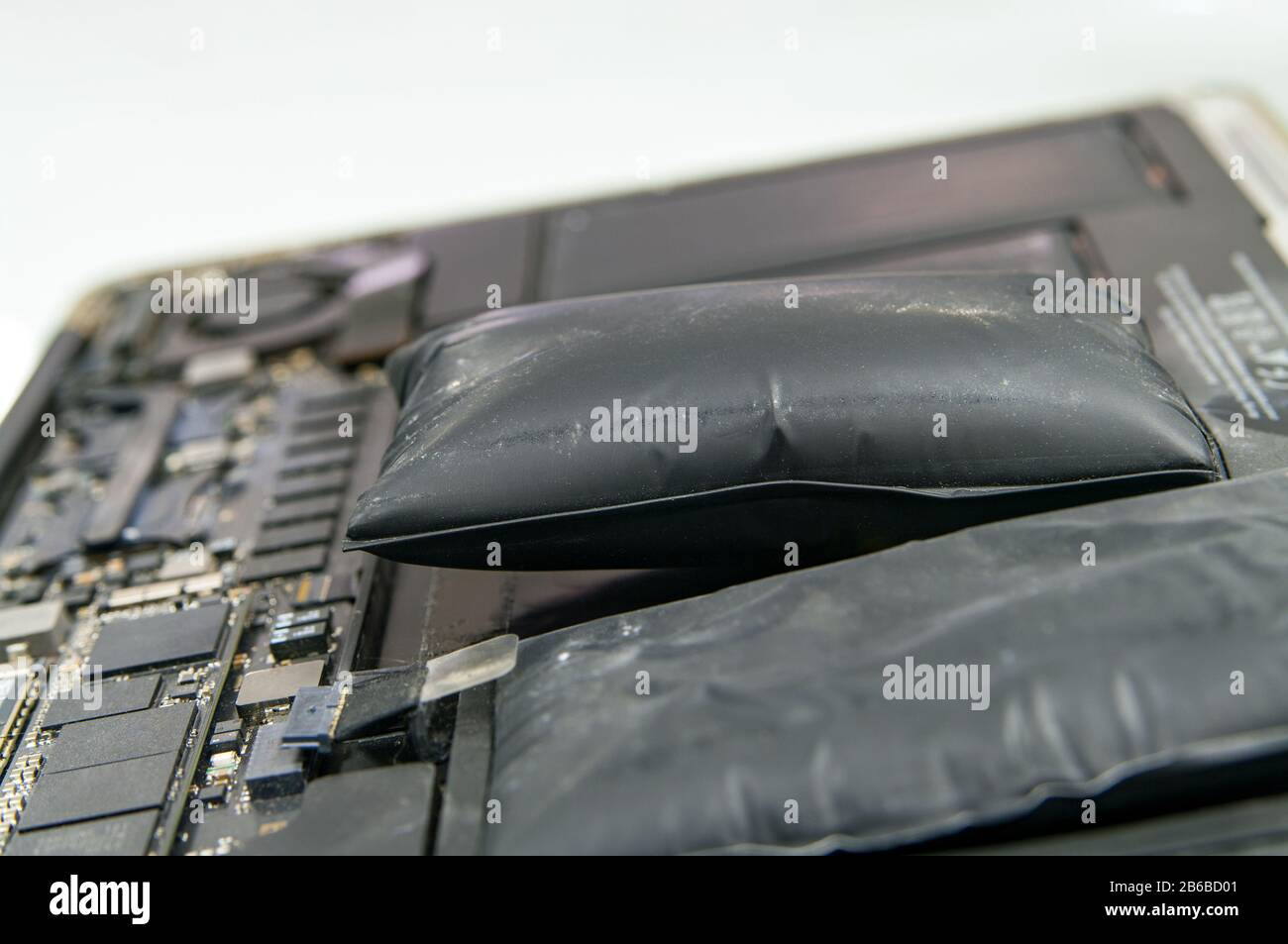 Lithiumion battery on laptop, which has expanded Stock Photo Alamy