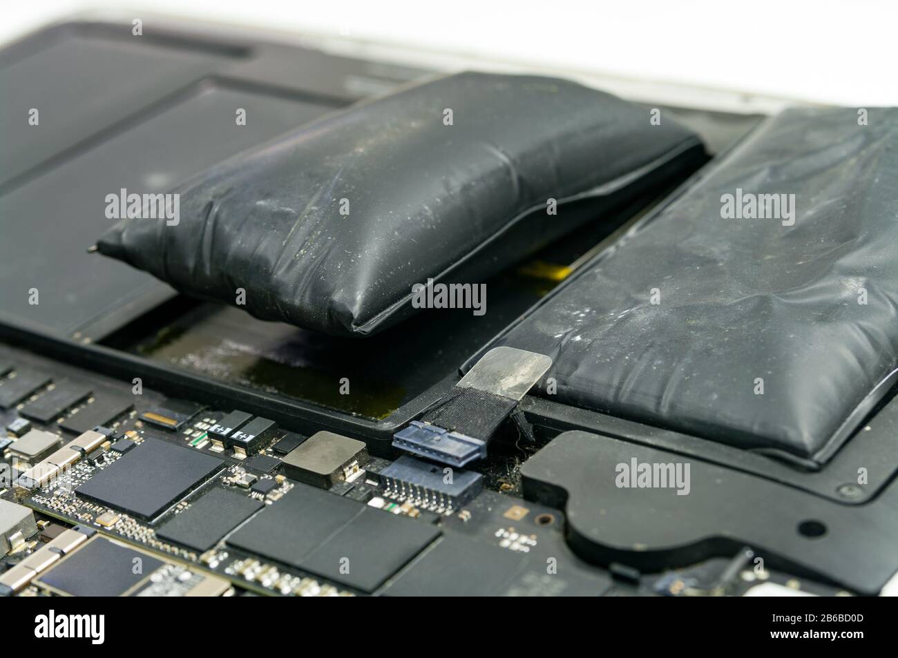 Lithiumion battery on laptop, which has expanded Stock Photo Alamy