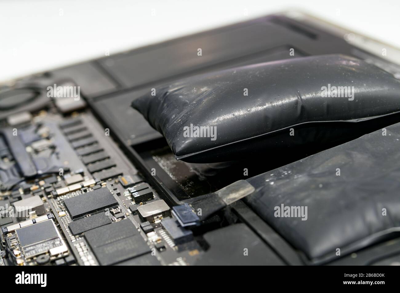 Lithiumion battery on laptop, which has expanded Stock Photo Alamy