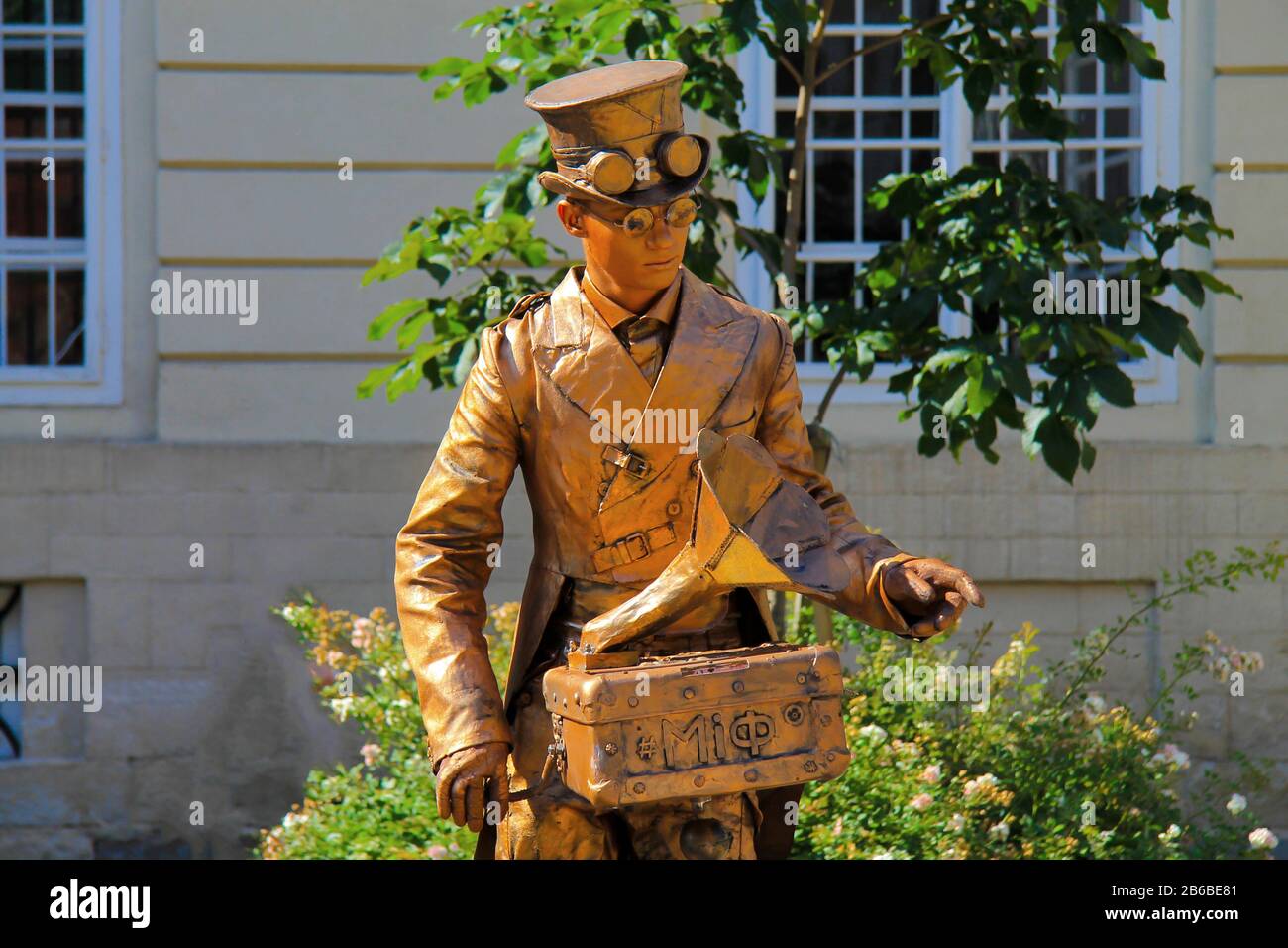 On the square in the Ukrainian city of Lviv there is a living statue in the form of an old organ-grinder in a yellow suit. Lvov Ukraine Stock Photo
