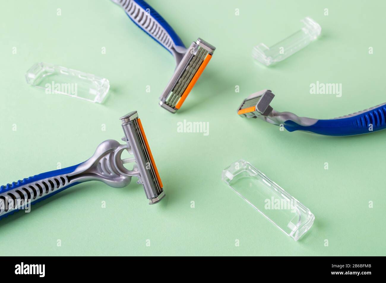 Three disposable shaving razors with triple blade lie in a circle on a