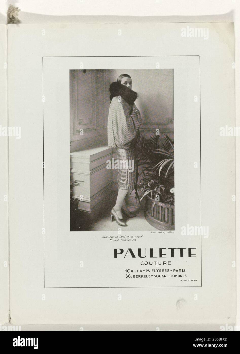 Ad: Woman in a casing of lame in gold and silver with a collar of fox fur,  from Paulette Couture. Page of the fashion magazine Art-Gout-Beauté  (1920-1933) . Manufacturer : Photographer: Sartony