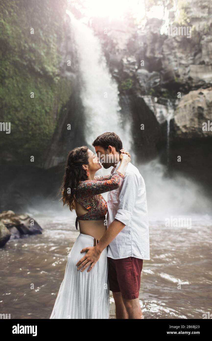 Spanish couple in love kissing with amazing view of waterfall. Happy  together, honeymoon in Bali. Travel lifestyle. Wanderlust concept Stock  Photo - Alamy