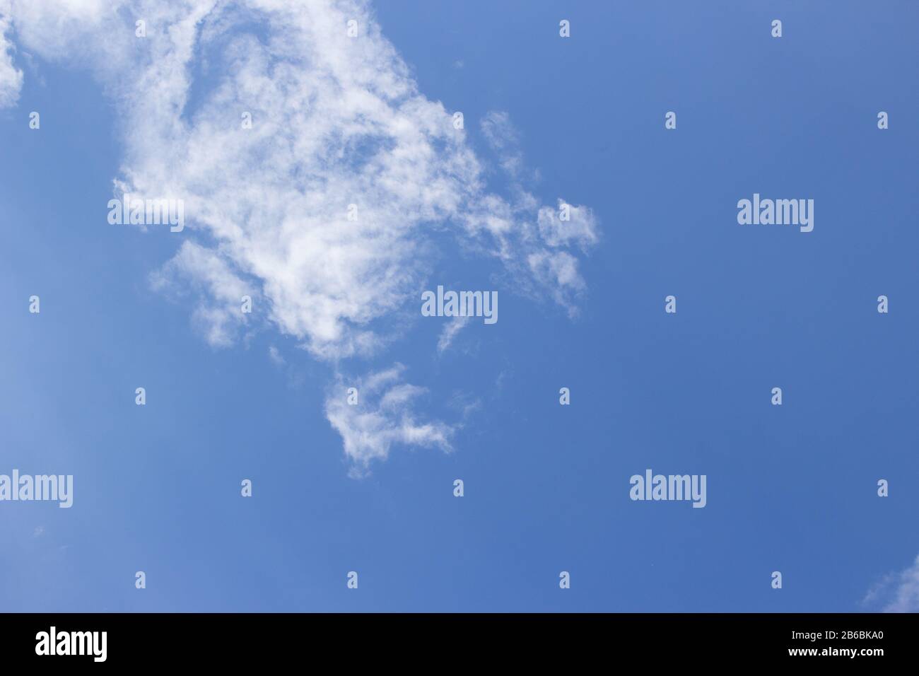 White curly clouds on a blue sky Stock Photo