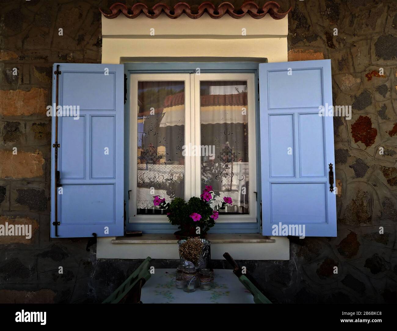 Traditional stone house with blue shades Stock Photo - Alamy
