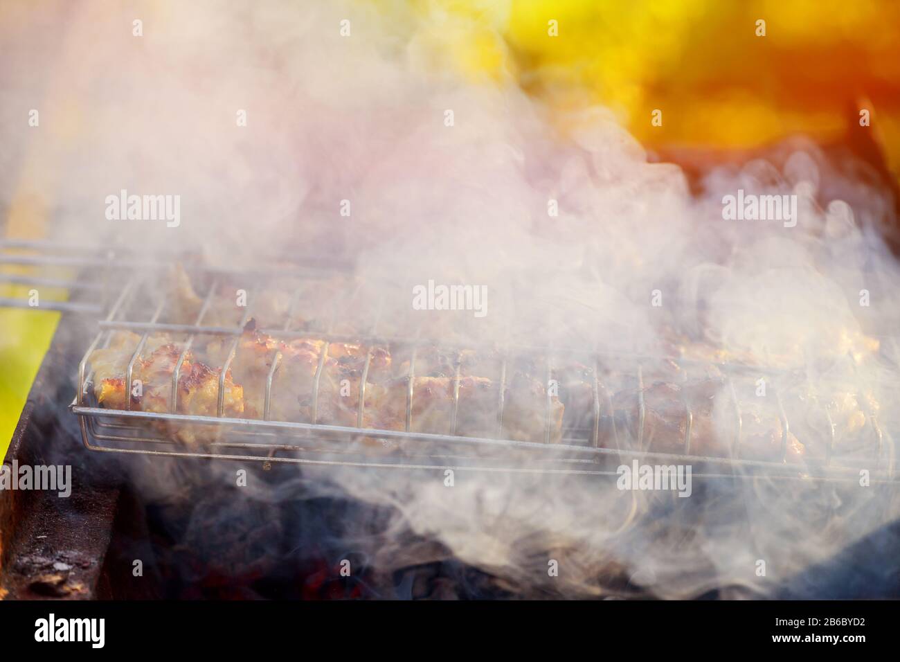Charcoal flames on a grilled chicken leg with BBQ grill Stock Photo Alamy