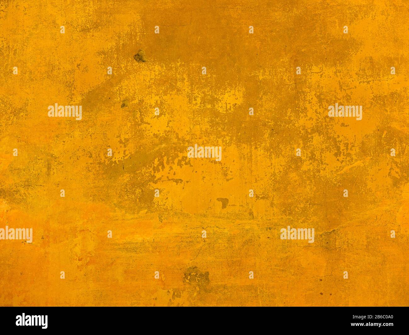 The texture of the wall with the chipped old antique plaster. Abstract background painted in Golden yellow Stock Photo