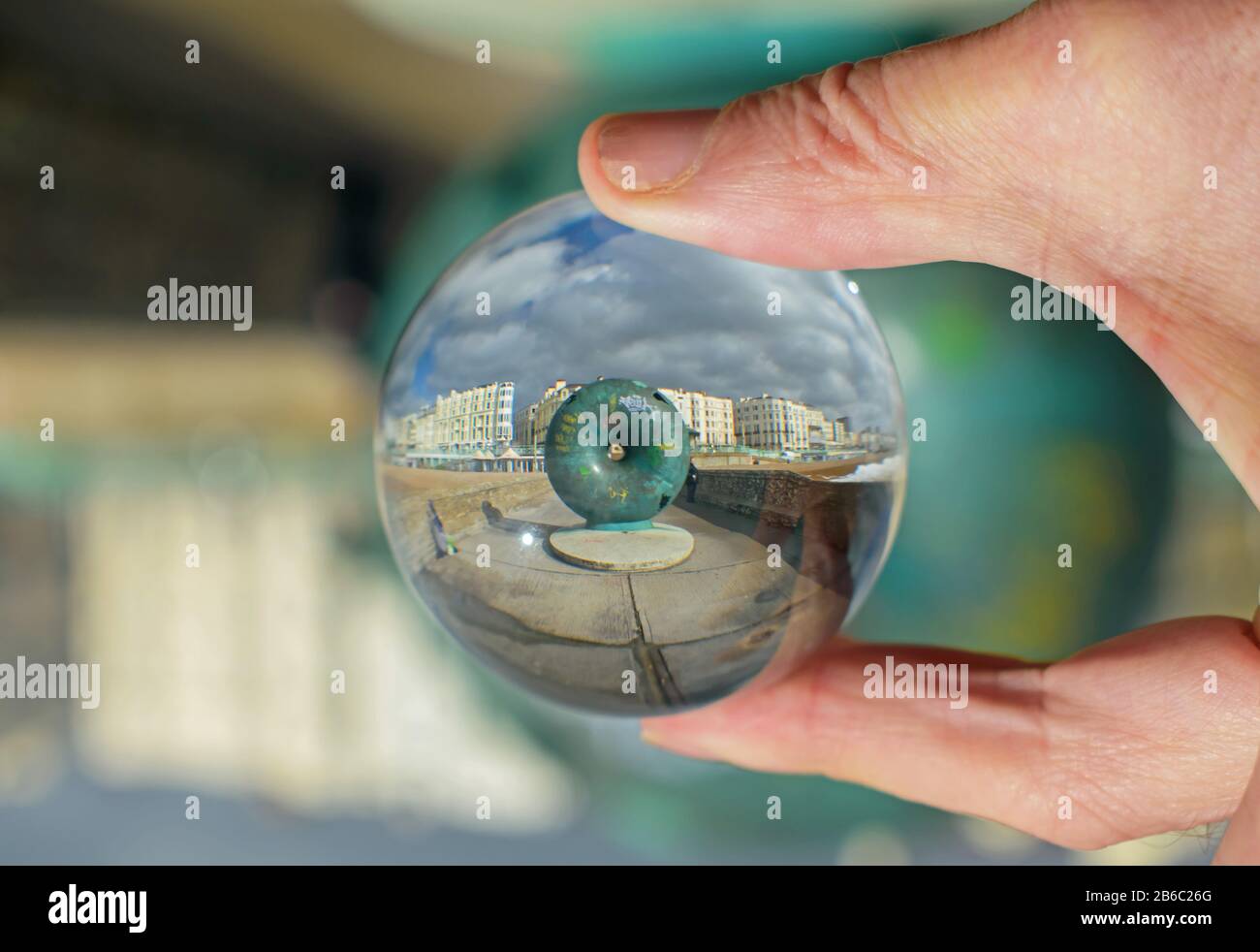 Brighton Seafront art and hotels seen through a lensball Stock Photo