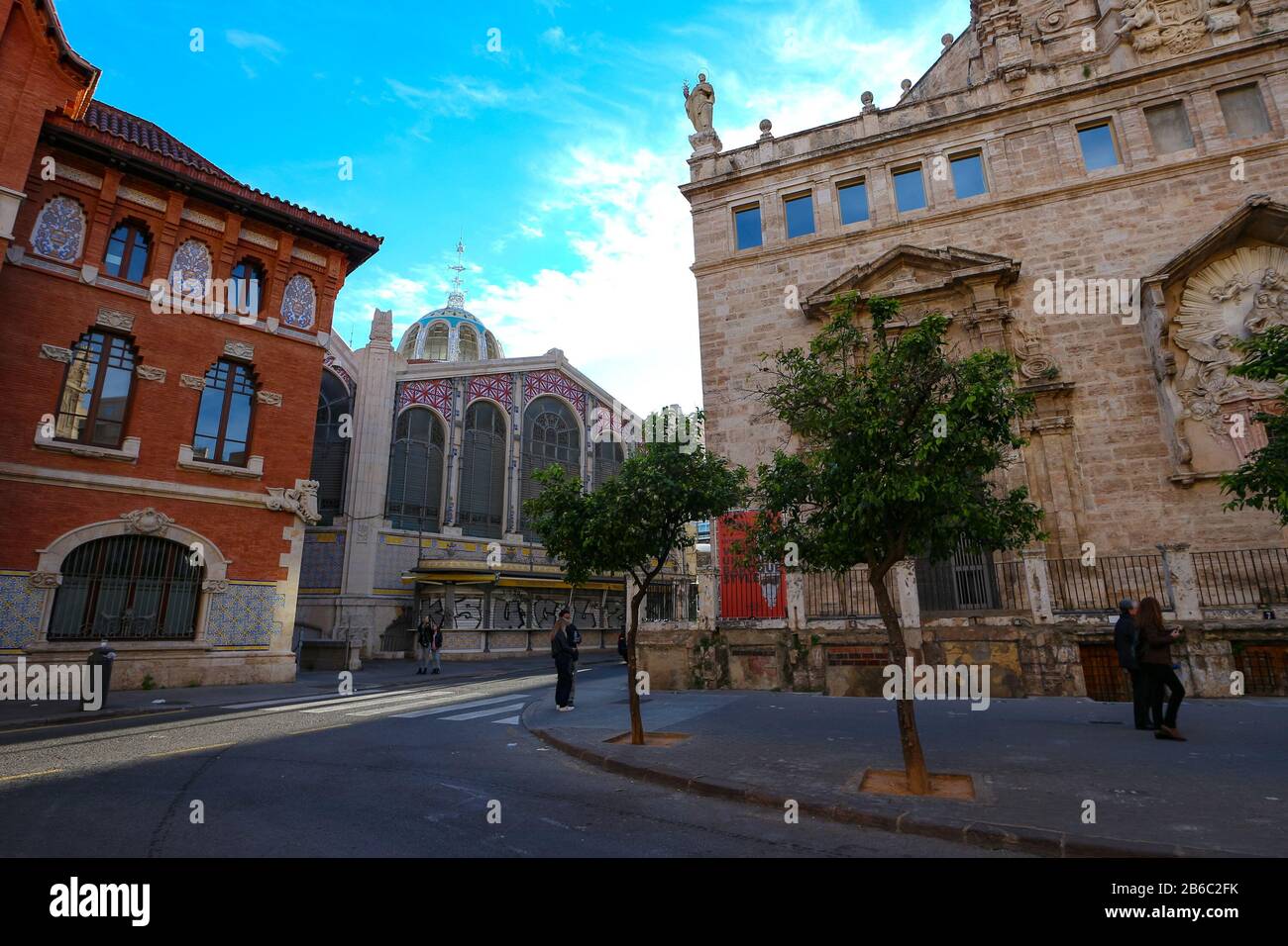 Street scene in historic Valencia, Spain, with the church Església de Sant Joan del Mercat and the Central Market building. Stock Photo