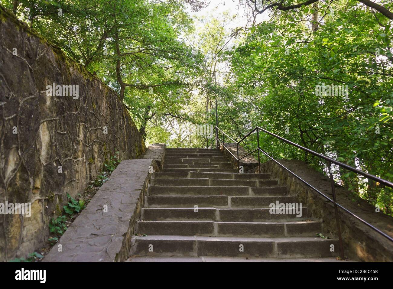 Old stone staircase in the shady Park of the southern village of Abrau-Durso in the Caucasus mountains. Move up Stock Photo