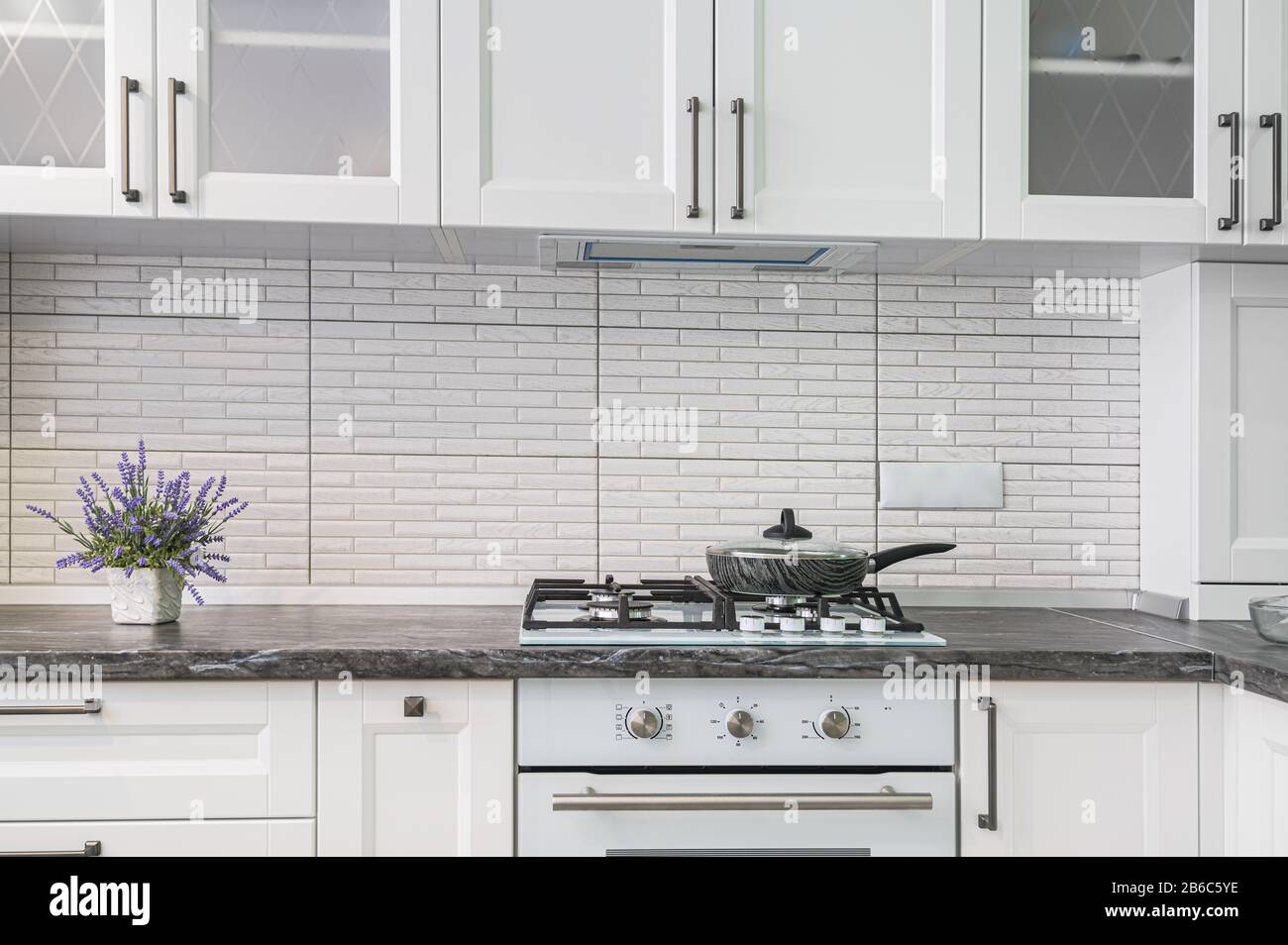 Modern white kitchen interior, front view Stock Photo - Alamy