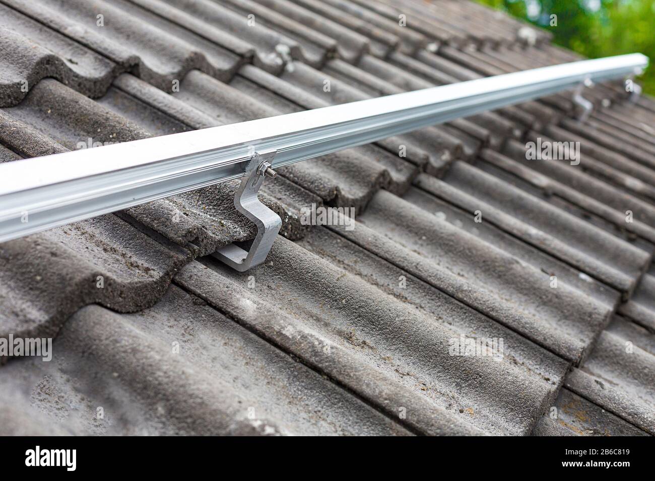 Close up of mounting rail for photovoltaic system on roof building site Stock Photo