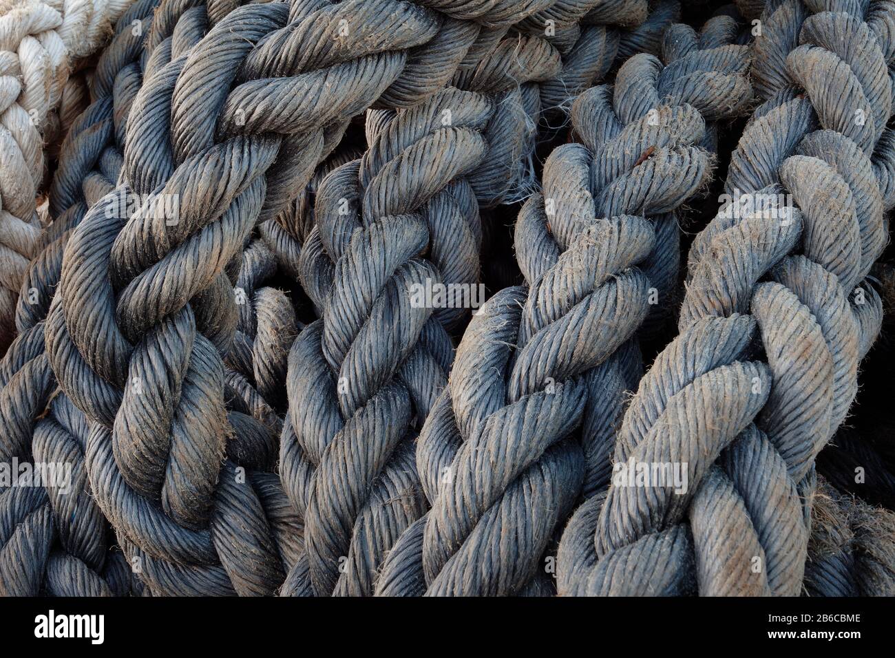 Pier of an old shipyard. Closeup of nautical ropes Stock Photo