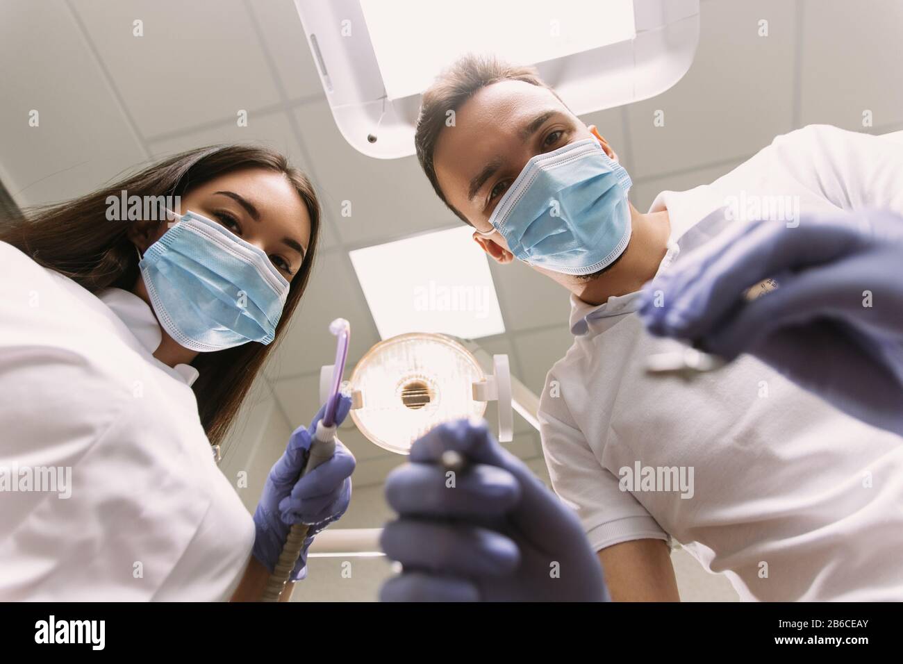 Dentist and assistant at a treatment, from the perspective of a patient