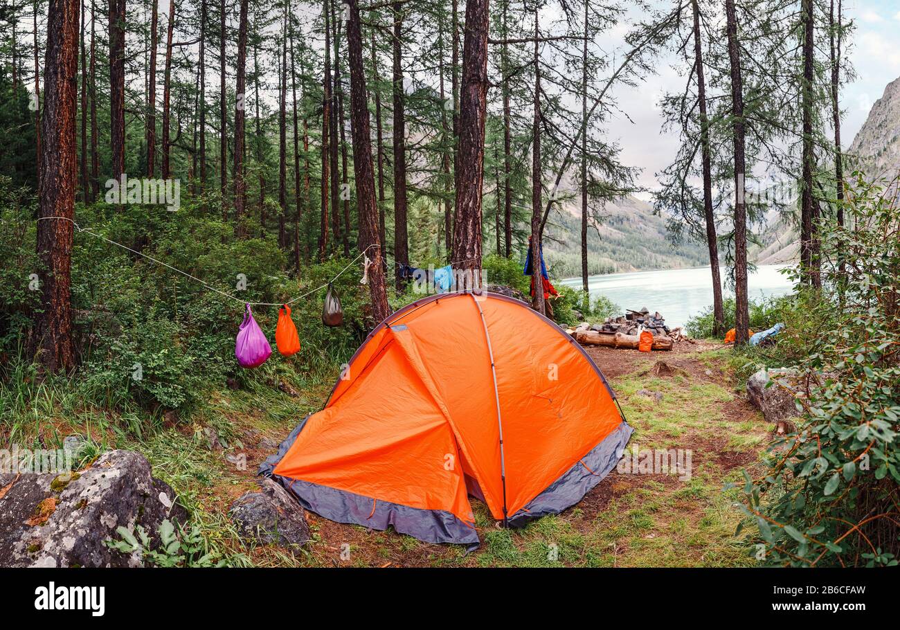 Camping Tent in the forest in front of mountain lake Stock Photo - Alamy