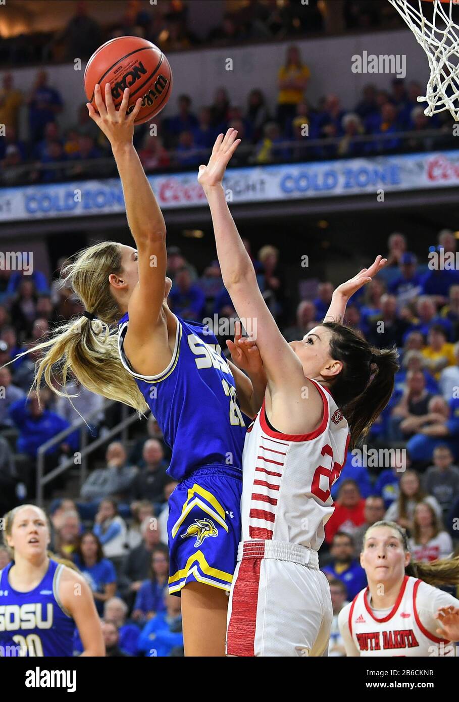 March 10, 2020: South Dakota State Jackrabbits guard Tylee Irwin (21) goes up for a shot over South Dakota Coyotes guard Ciara Duffy (24) during the Summit League women's championship basketball game between the South Dakota State Jackrabbits and the South Dakota Coyotes at the Denny Sanford Premier Center, Sioux Falls, SD. South Dakota defeated South Dakota State 63-58 and move on to the NCAA tournament. Photo by Russell Hons/CSM Stock Photo