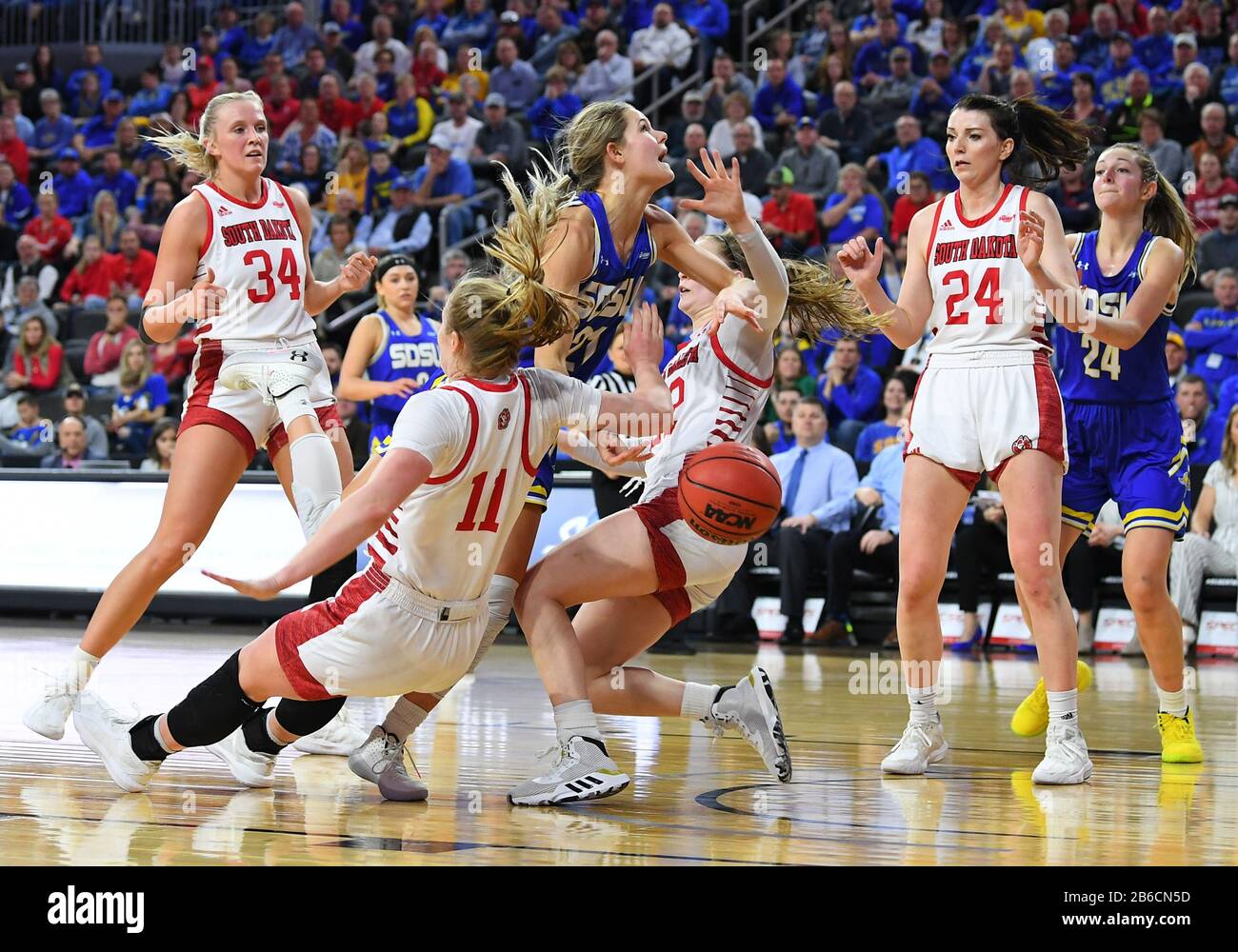 March 10, 2020: South Dakota State Jackrabbits guard Tylee Irwin (21) knocks over several defenders on her way to the basket in the Summit League women's championship basketball game between the South Dakota State Jackrabbits and the South Dakota Coyotes at the Denny Sanford Premier Center, Sioux Falls, SD. South Dakota defeated South Dakota State 63-58 and move on to the NCAA tournament. Photo by Russell Hons/CSM Stock Photo