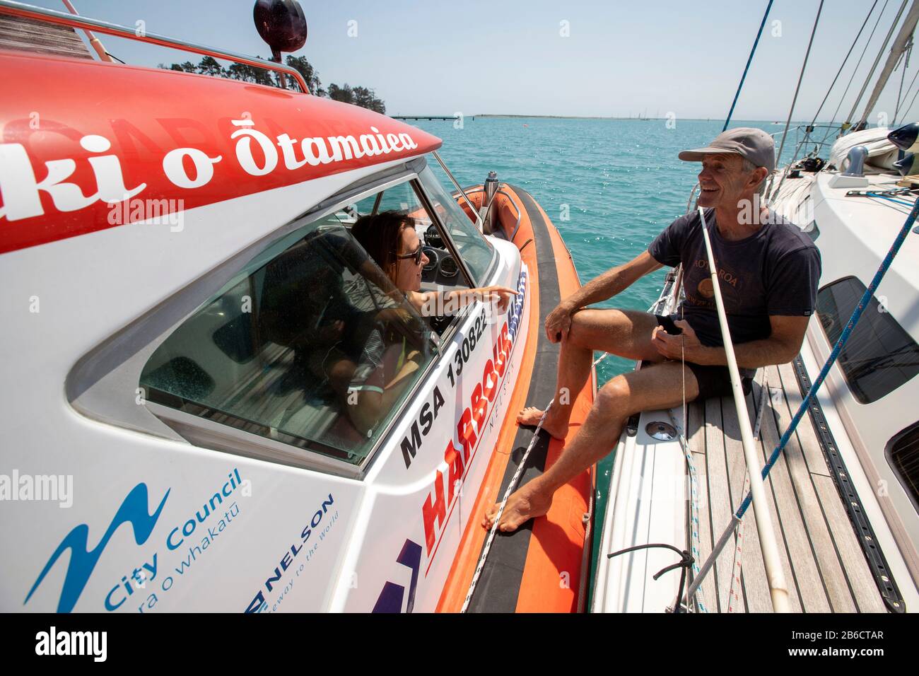 Port Nelson deputy harbourmaster Amanda Kerr on the waters off Port Nelson, Nelson, New Zealand Stock Photo