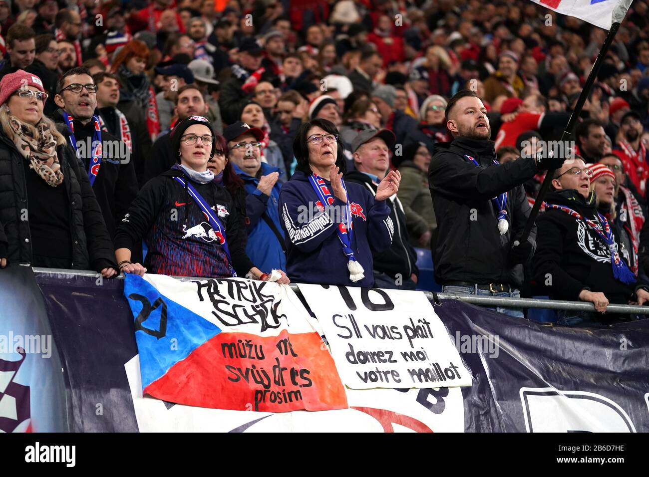 RB Leipzig fans celebrate their victory in the stands during the UEFA Champions League round of 16 second leg match at the Red Bull Arena, Leipzig. Stock Photo