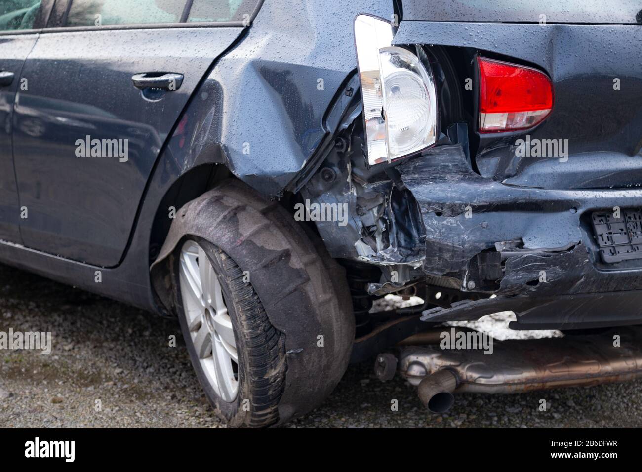 Damaged rear of a car caused by an accident Stock Photo