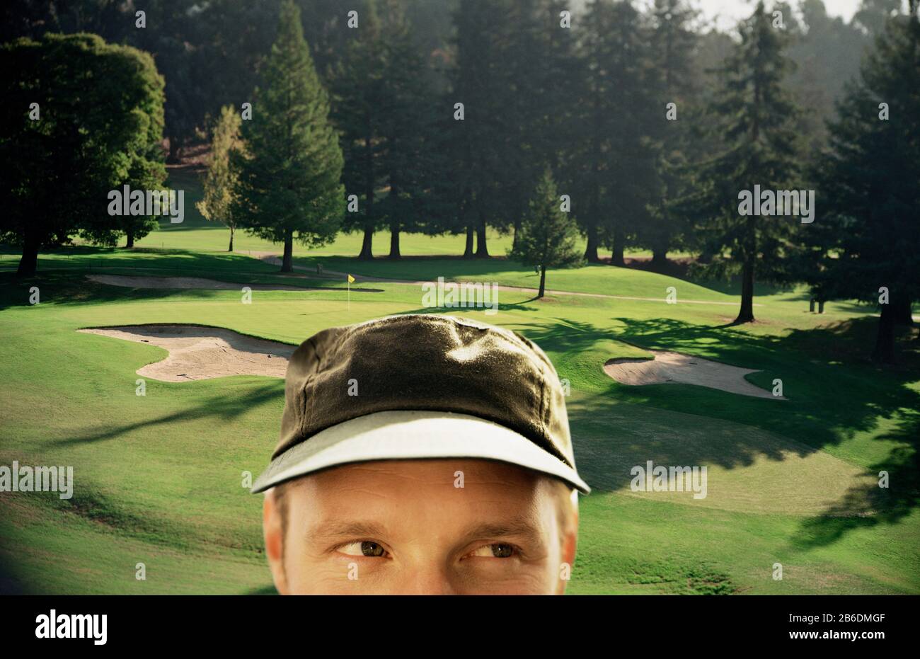 Close up of a man with a golf course in the background. Stock Photo