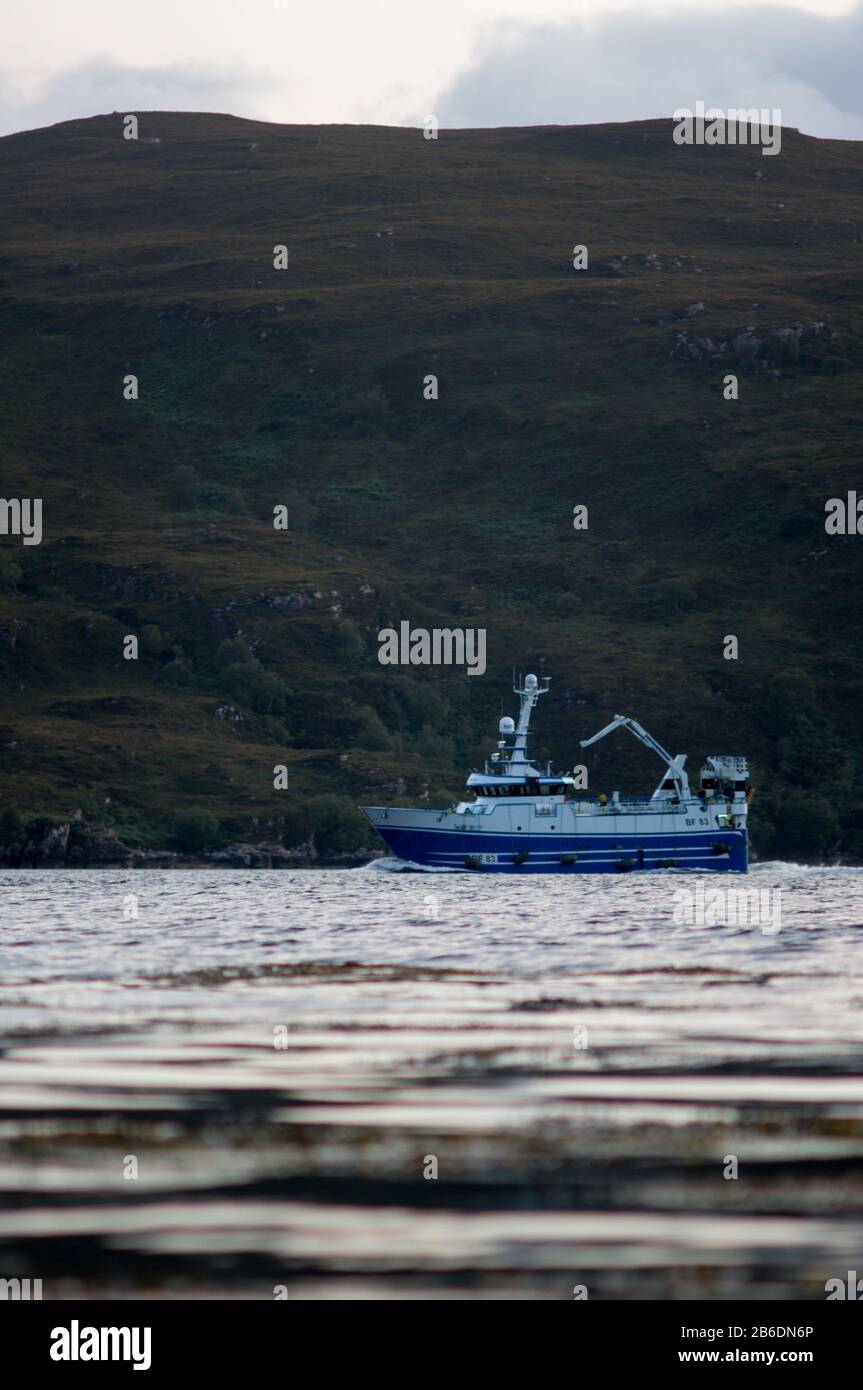 Fishingboat at sea in front of Mountains, Scotland Stock Photo