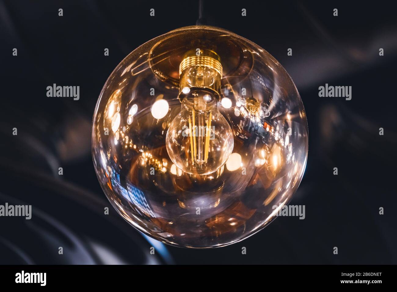 Giant vintage style light bulb with its retro filaments visible inside Stock Photo