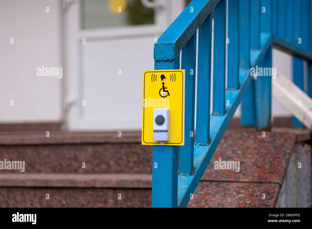 Bell button to call staff for wheelchair users near the pharmacy stairs Stock Photo