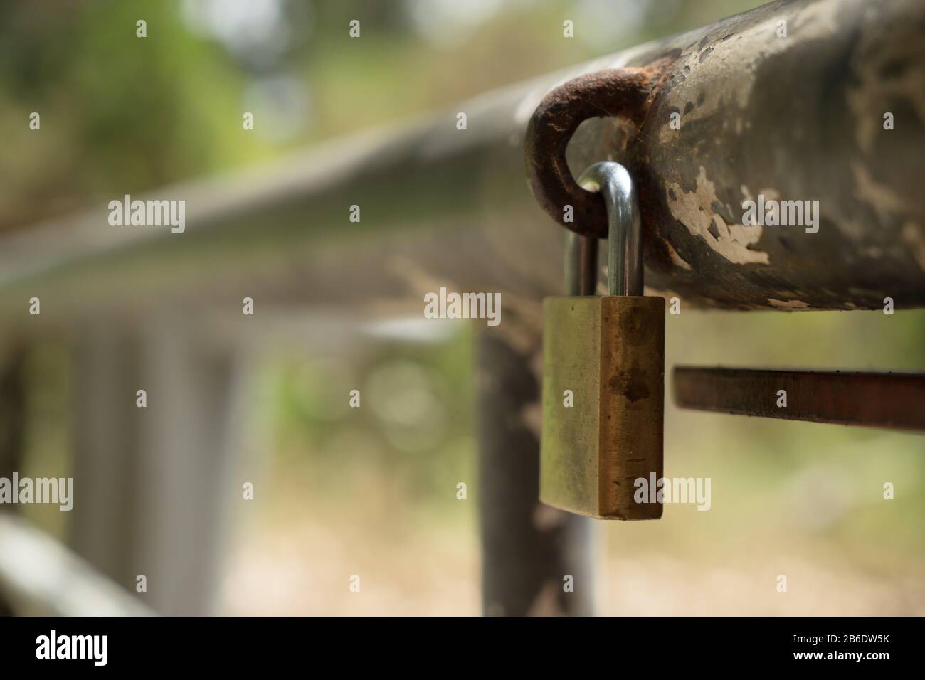 Padlock on gate across steel gate at entrance to a forest track, River