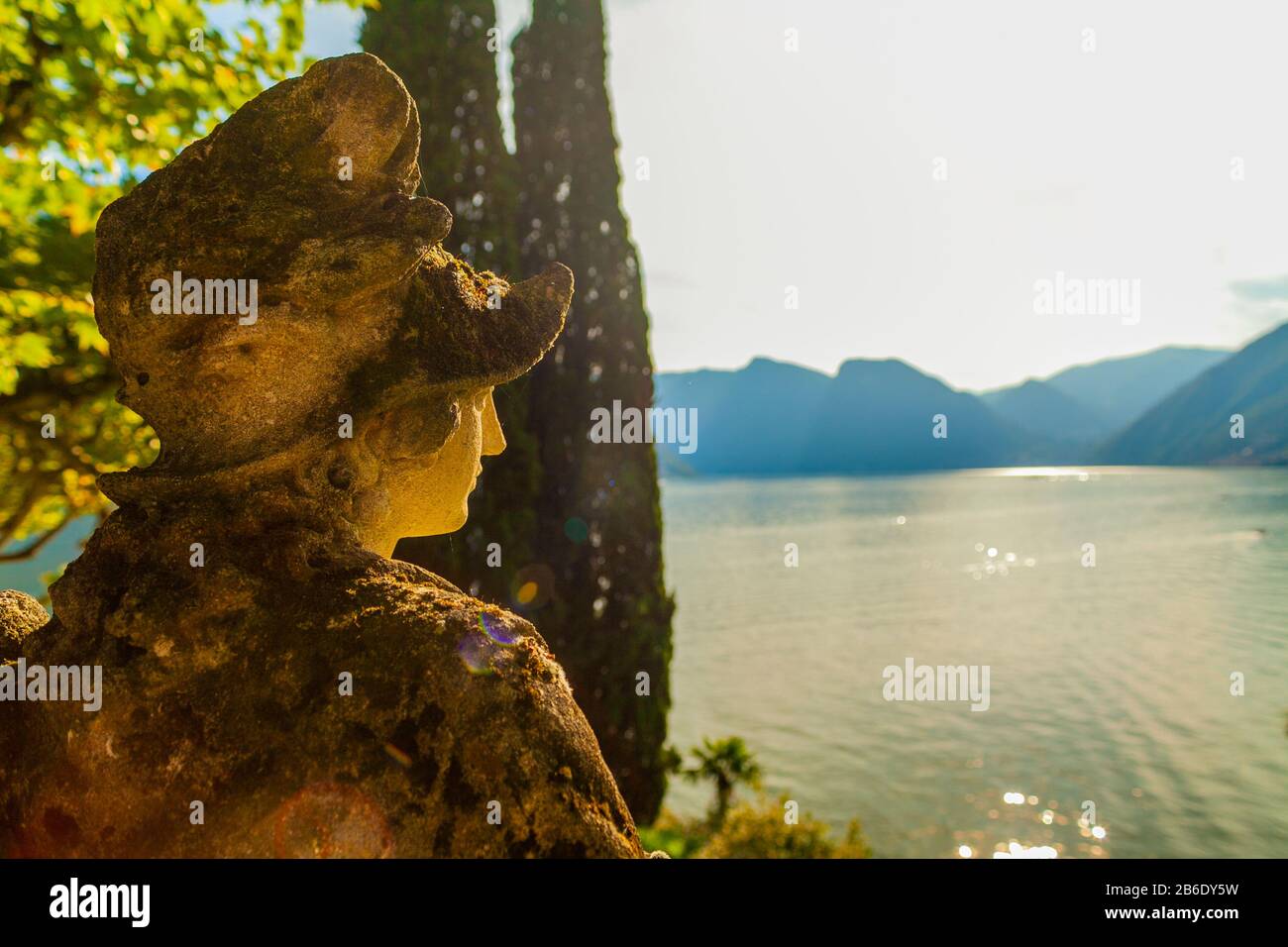 Lake Como landscape with sculpture on foreground at sunset Stock Photo