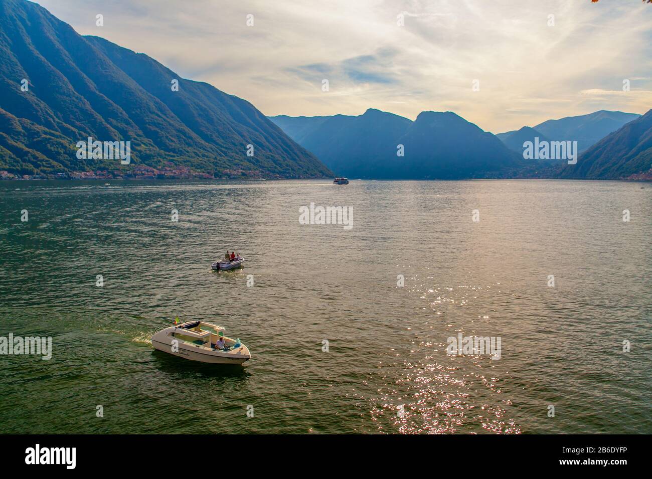 Boats on Lake of Como in Lombardy, Italy, at sunset Stock Photo