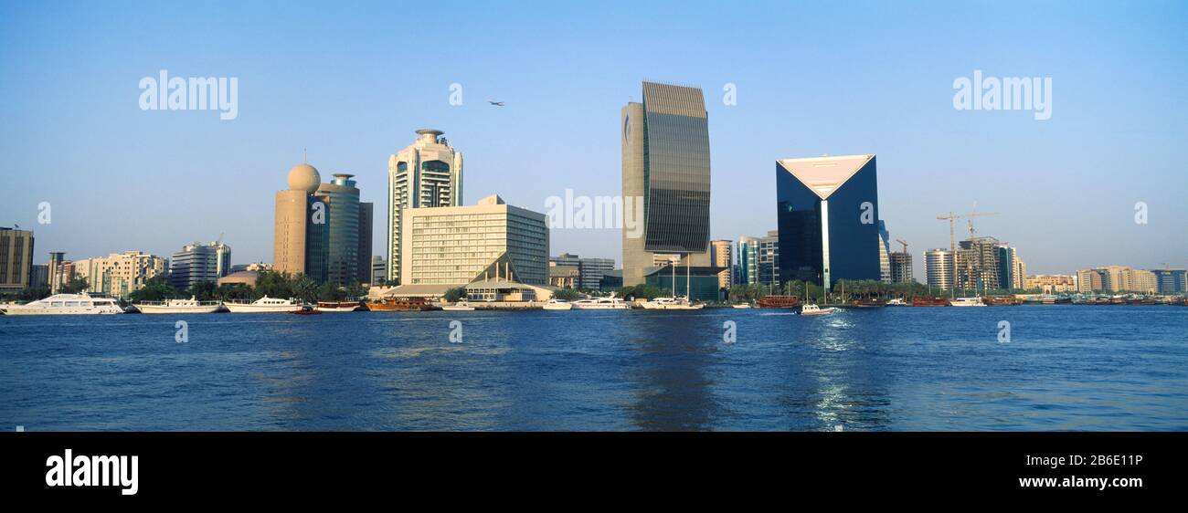 City at the waterfront, National Bank Of Dubai, Dubai Chamber Of Commerce And Industry, Dubai Creek, Dubai, United Arab Emirates Stock Photo