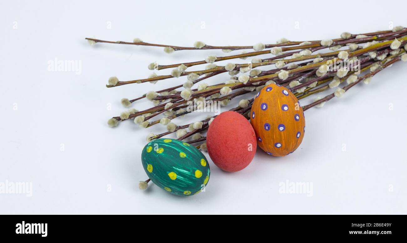 Easter eggs. Happy easter card. Multi-colored Easter eggs with willow. Easter eggs on a white background. Copy space. Place for text Stock Photo