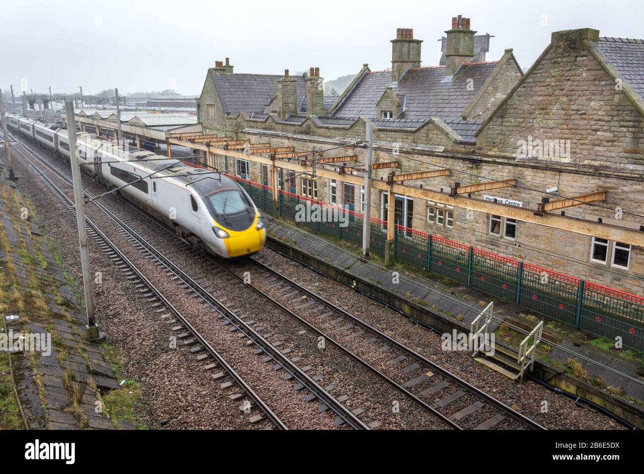 Carnforth Railway station, motion blur of high speed non-stop train passing through. Stock Photo