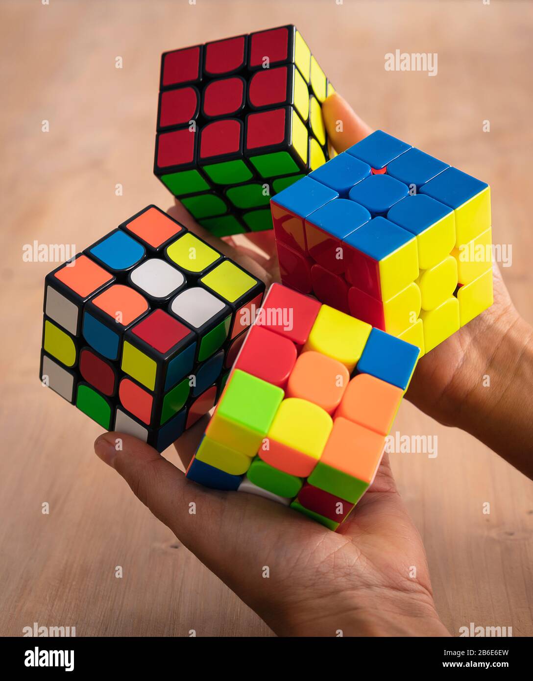 Several Rubik cubes intelligence toys unsolved, in a wood table Stock