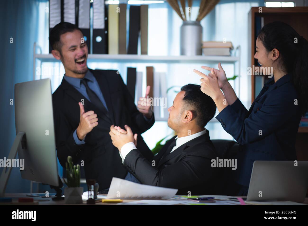 young asian business person giving coworker high five in office ...
