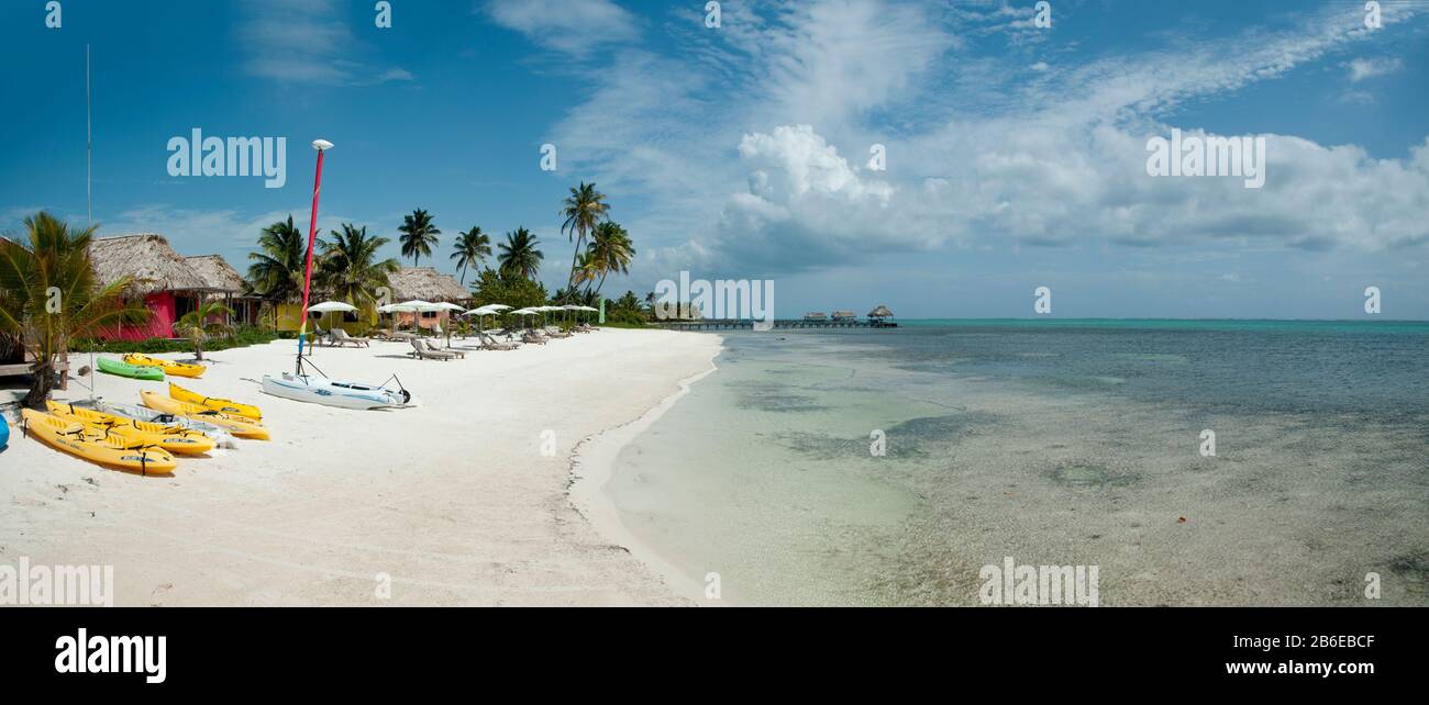Palm trees and thatched roof huts on the beach, Matachica Beach Resort
