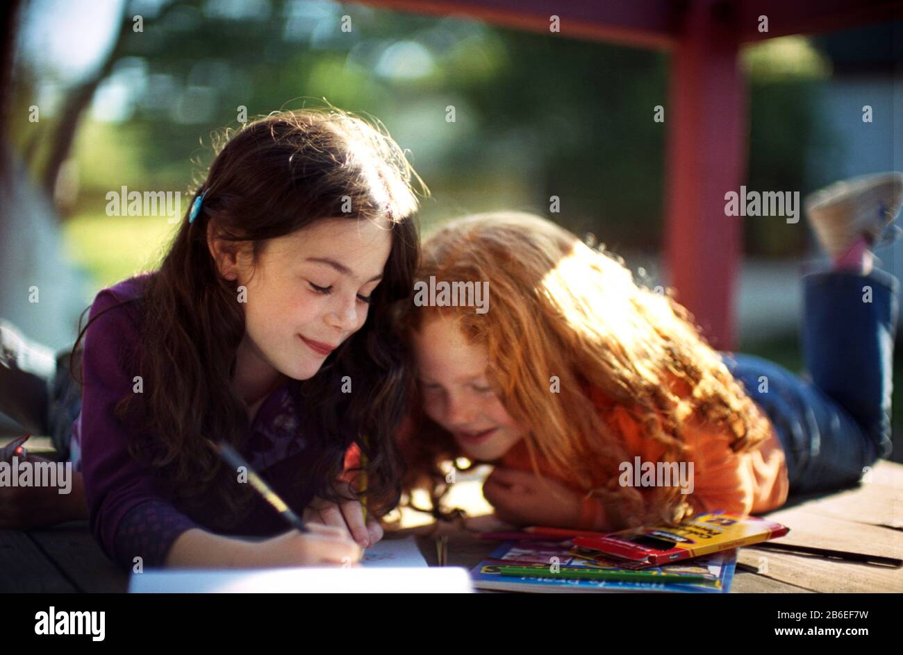 Two little girls colouring in Stock Photo