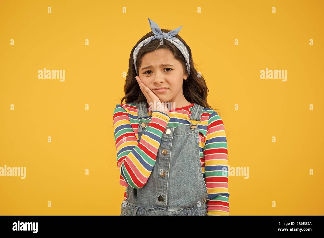 Dentist appointment. Little child suffer from toothache yellow