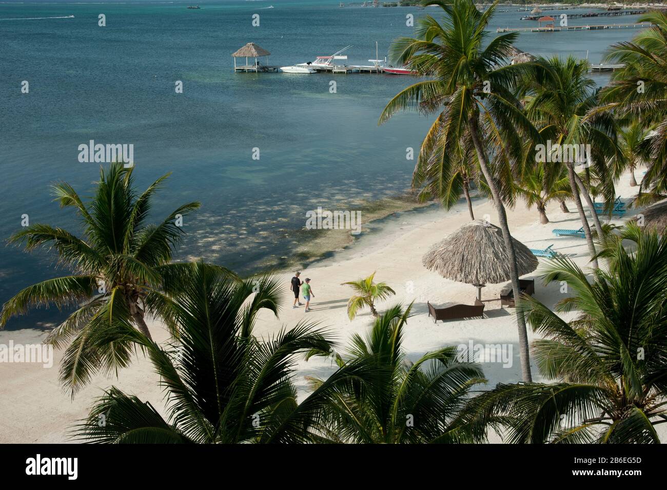Couple walking on beach, San Pedro, Ambergris Caye, Corozal District