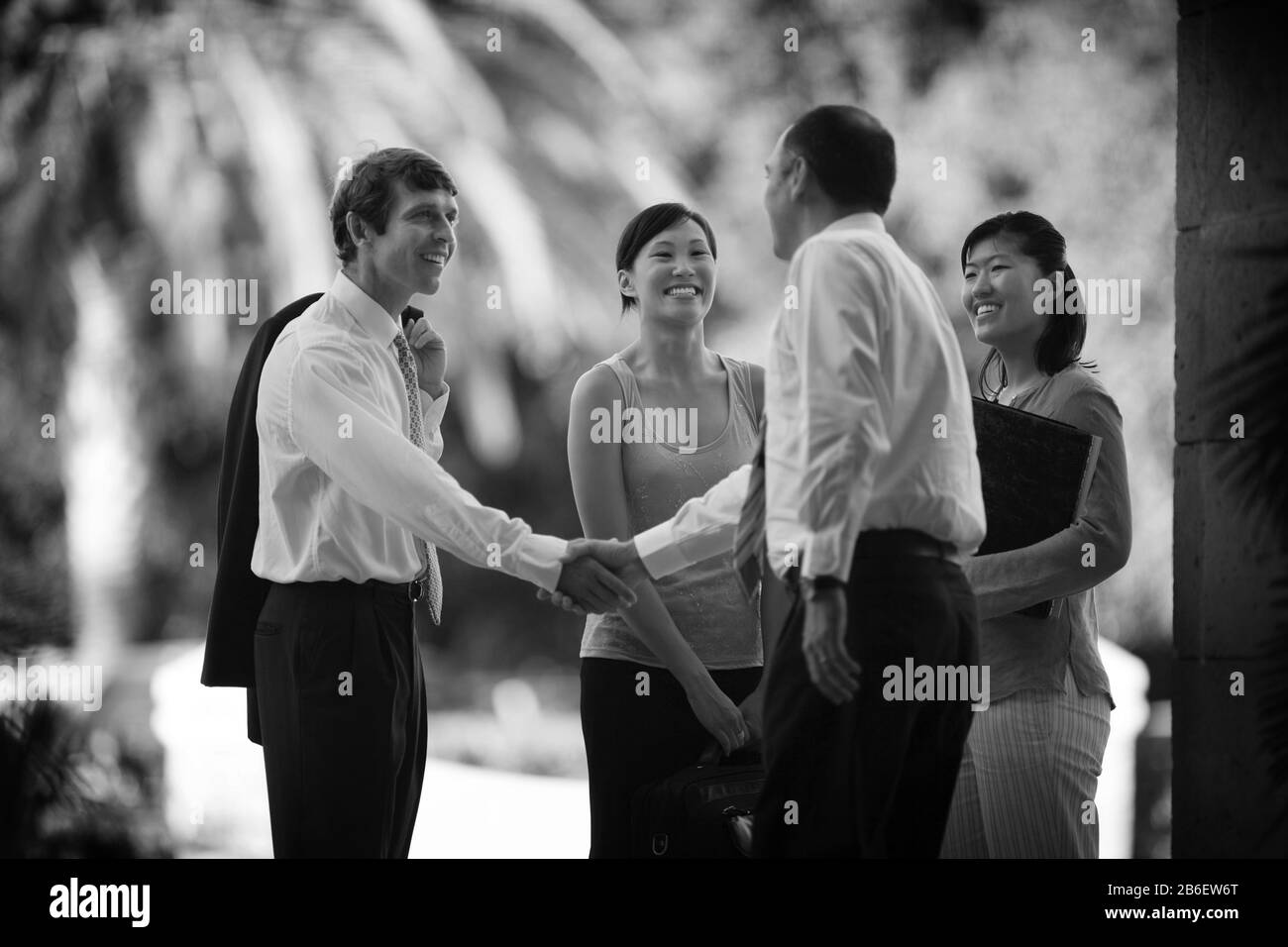 Business executives greet each other outside the building. Stock Photo