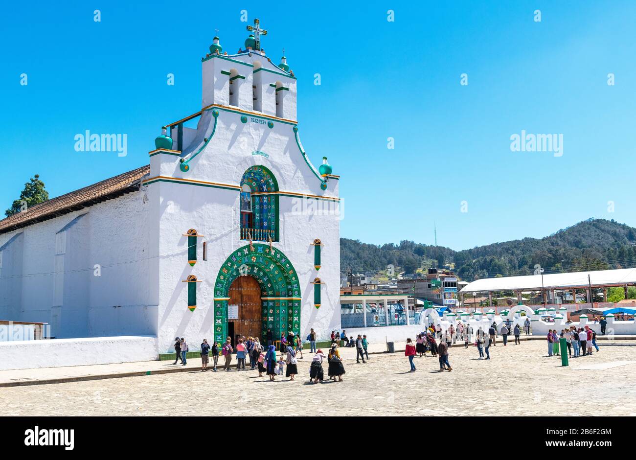 Indigenous Mayan people walking into the church dating from the 16th century in San Juan Chamula near San Cristobal de las Casas, Mexico. Stock Photo