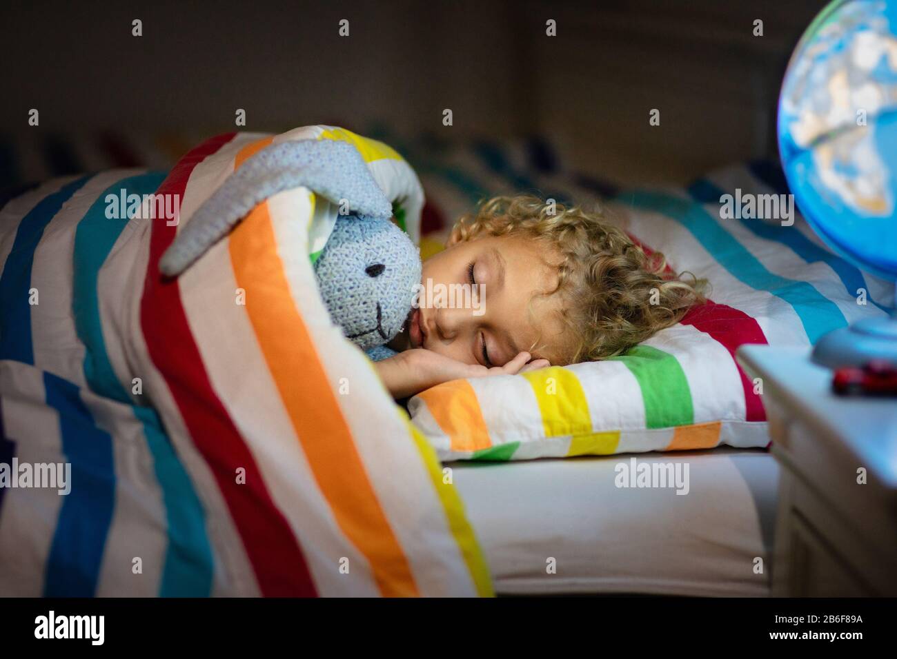 Child sleeping at night. Kids sleep. Little boy relaxing in bed with ...