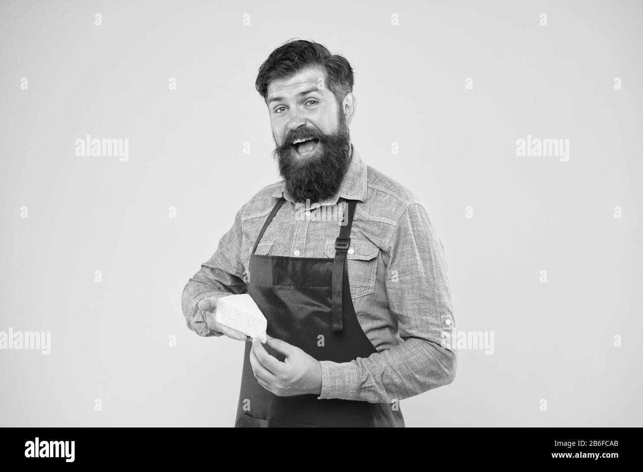 Lactose. Gourmet product. Dairy product derived from milk. Cheese making techniques. Online shopping. Diet and nutrition. Cheesemaking concept. Cheese maker. Bearded man in apron hold piece cheese. Stock Photo