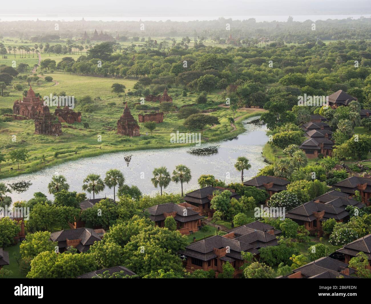 Villas at Aureum Palace Hotel and nearby stupas in the Bagan plain, Mandalay Region, Myanmar Stock Photo