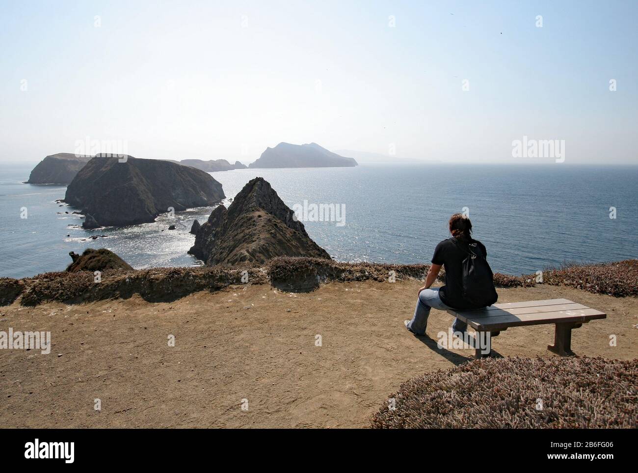 Young woman at Inspiration Point on East Anacapa Island in Channel Islands National Park, California on sunny summer afternoon. Stock Photo